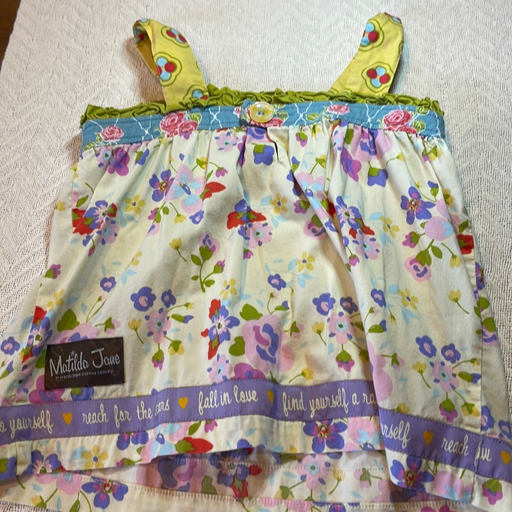 A shirt for kids with a button on the front side six